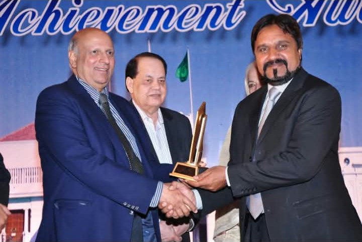 Ch. Munawar Hussain receiving the Achievement Award from the Governor of Punjab
